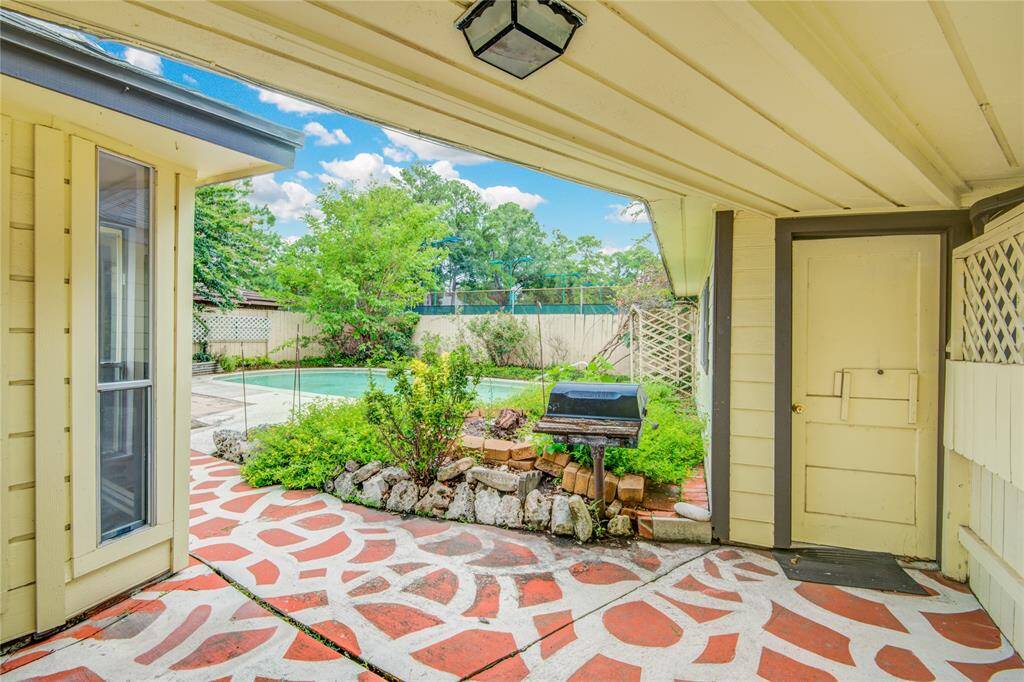 Patio breezeway connecting the home to the garage. The sunroom is visible on the left.