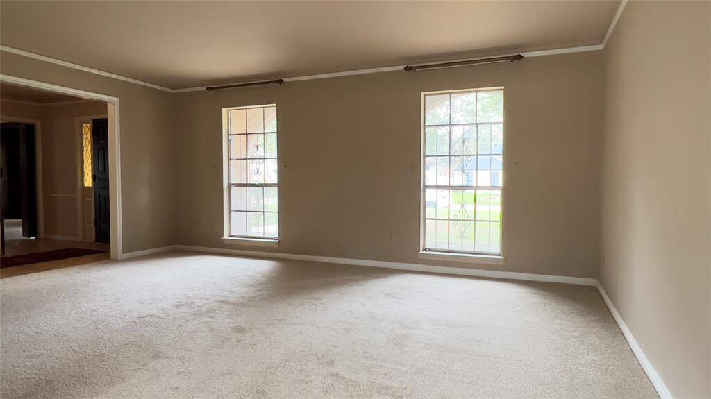 The formal living room is open to the foyer on the left. This is a great space for a massive dining room or office.