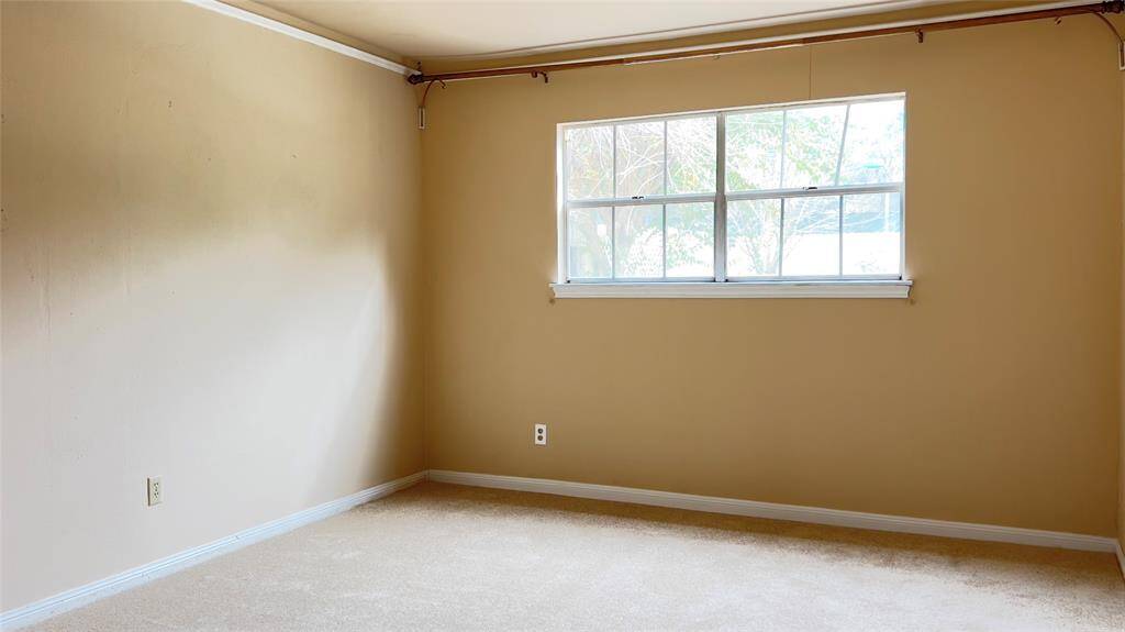 The formal dining room overlooks the back patio and pool.