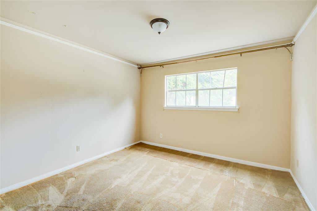 An alternate view of the formal dining room showcases natural light from the window overlooking the patio and pool area.