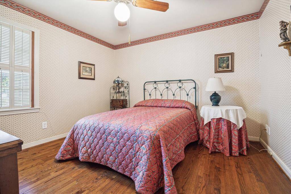 [SECOND BEDROOM] The second bedroom offers a cozy and inviting space perfect for guests, a child’s room, or a home office. Filled with natural light and accented by original hardwood floors, it continues the home’s classic charm with clean lines and a neutral palette.