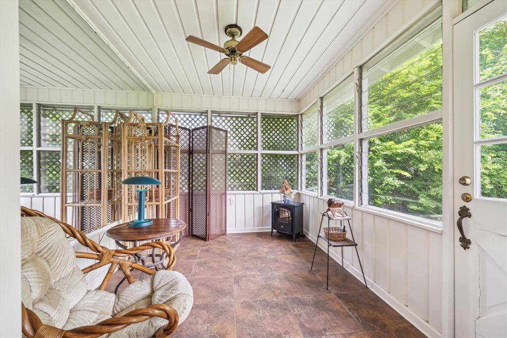 [SUNROOM] hether you use it as a peaceful retreat, a plant-filled sanctuary, or a cozy entertaining space, the sunroom offers a seamless blend of indoor comfort and outdoor charm. Its light-filled ambiance and views of the surrounding greenery create a serene backdrop for relaxation year-round.