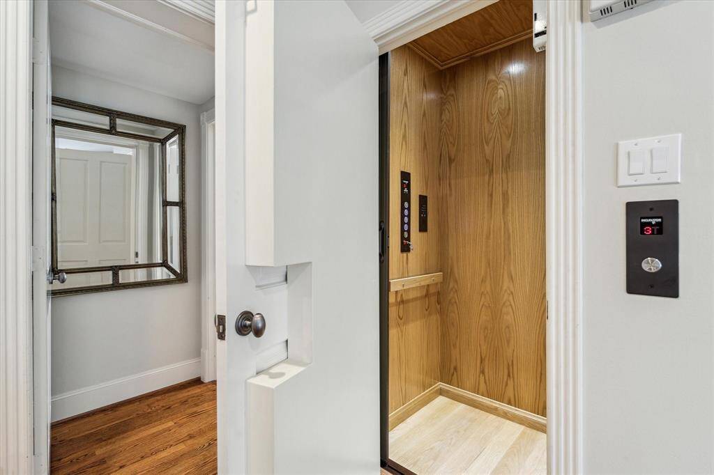 This luxury home features a sleek Inclinator elevator with a 500 lb capacity, providing convenient access between the first, second, and third floors. The elevator combines modern functionality with elegant design, seamlessly integrating into the home’s sophisticated layout.