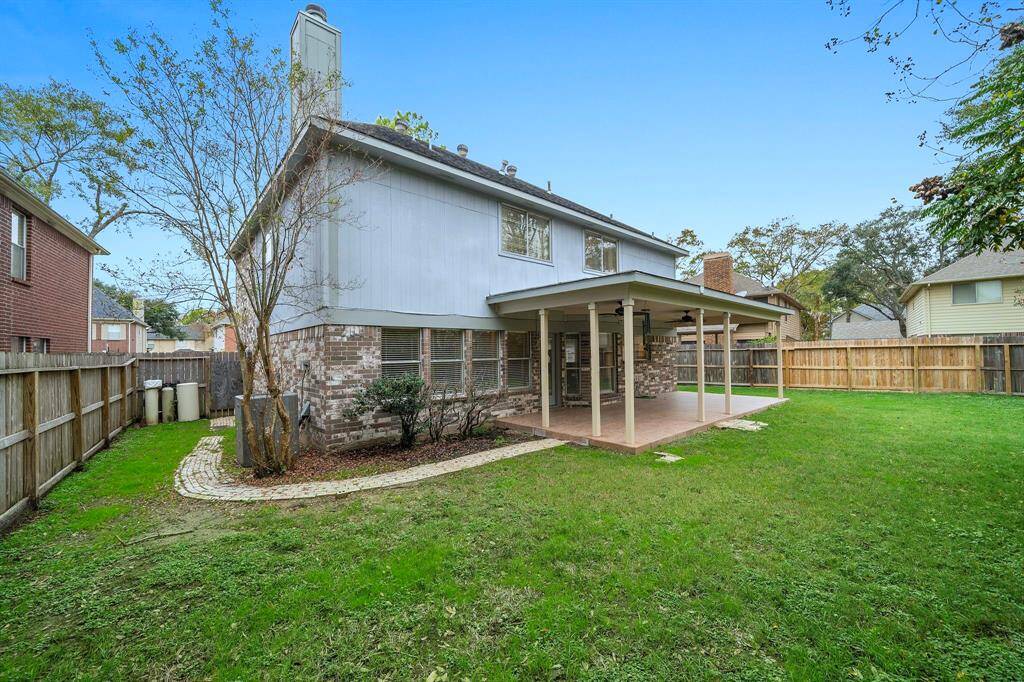 The backyard features a fully fenced perimeter, and spacious covered patio perfect for entertaining, relaxing, and playing!