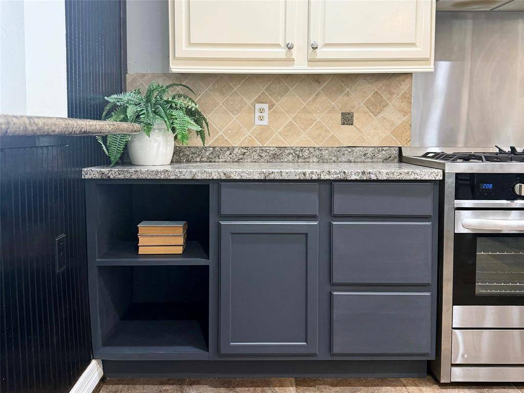 This versatile space is perfect for a coffee station, built-in microwave, or organized cookbook storage — offering both utility and convenience right where you need it.