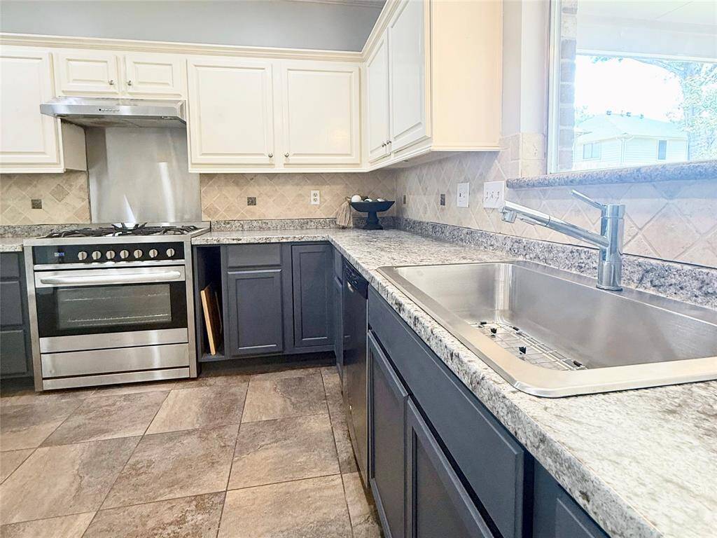 Enjoy the convenience of a massive 33" single-bowl sink perfect for large pots and trays, plus custom built-in vertical storage that keeps cutting boards and bakeware easily accessible and organized.