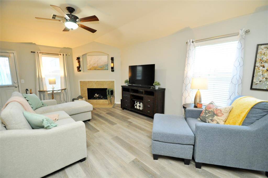 Another view of the family room.  Love the corner fireplace and the added ceiling fan.  The windows add the extra brightness to the space.