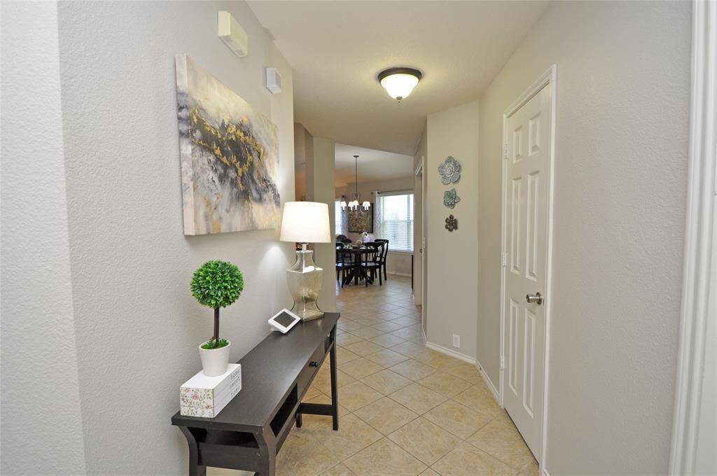 Upon entering the home you have a long hallway leading to the dining and family room.