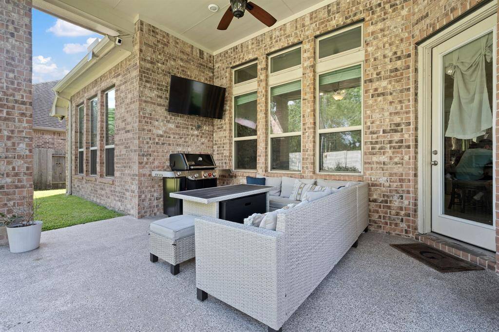 This outdoor patio is perfect for entertaining. Ceiling fan to help stay cool on summer days.