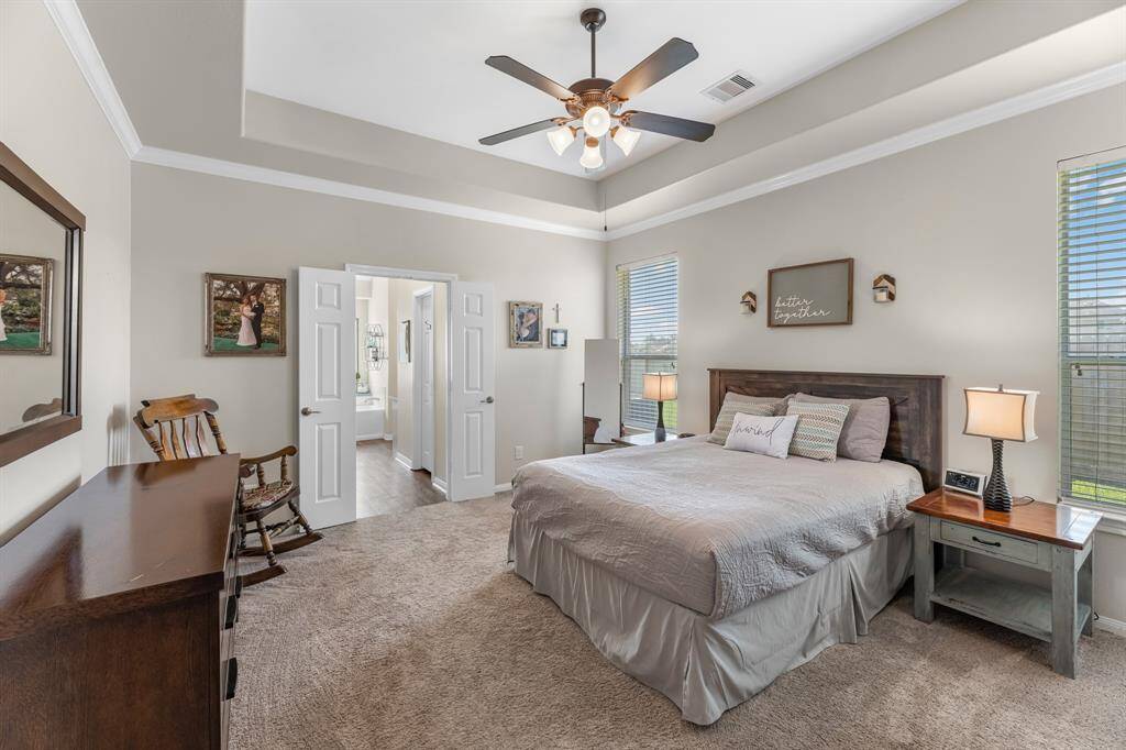 Charming primary bedroom with trey ceilings, and soft tone paint. Cozy!
