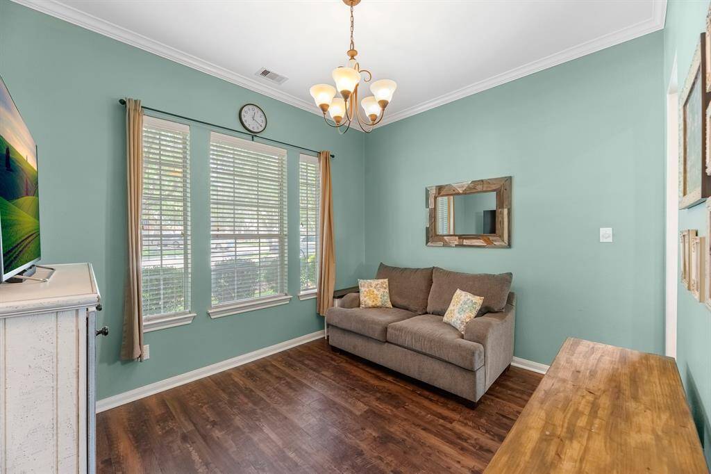 Front formal dining area adjacent to the kitchen. Space has versatility and can be used as a flex space, game, or second living area.