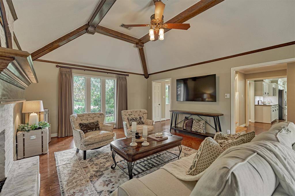 Elegant French doors lead to a serene backyard with pool and patio.