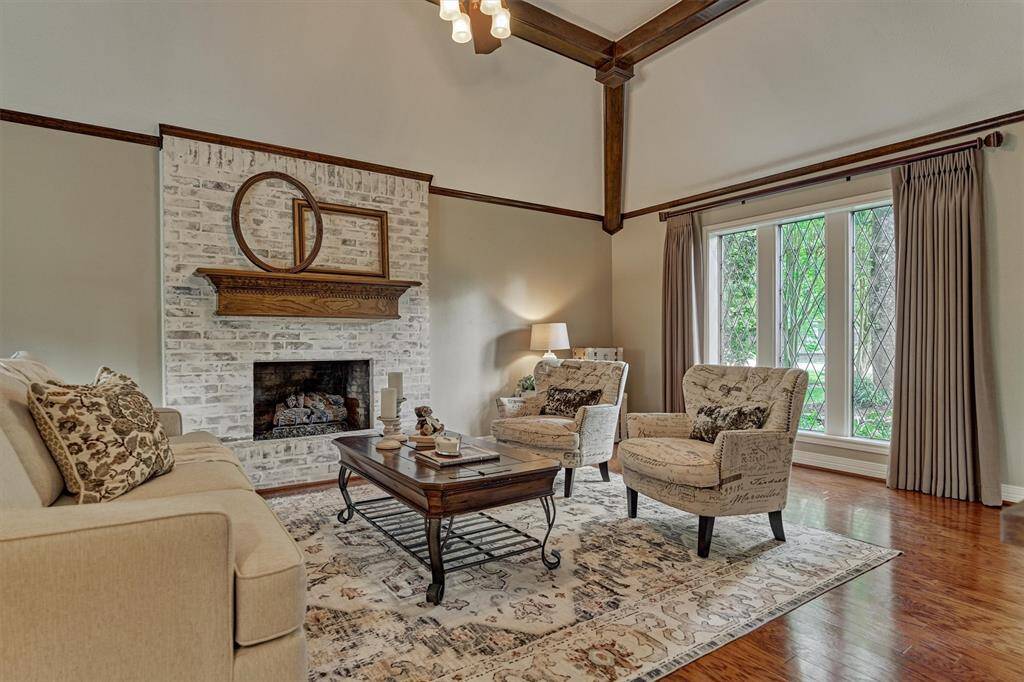 Elegant full brick fireplace with a charming German schmear finish and cozy gas logs.