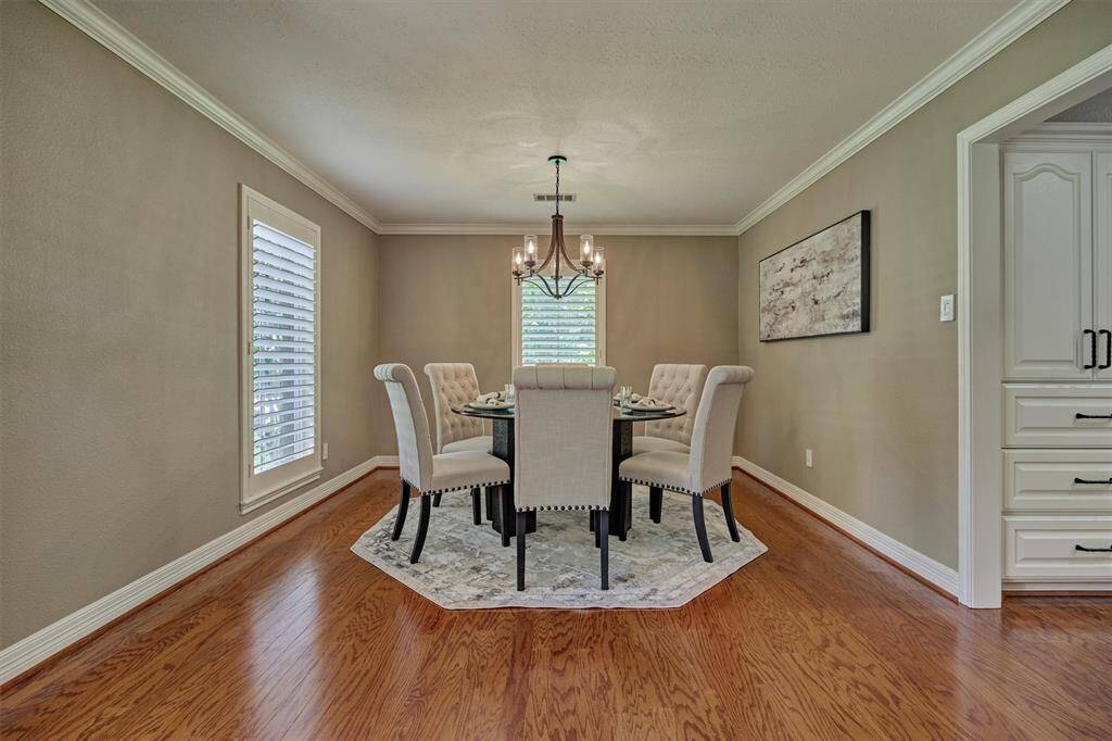 Polished dining room with hardwood floors will accomodate large gatherings with ease.