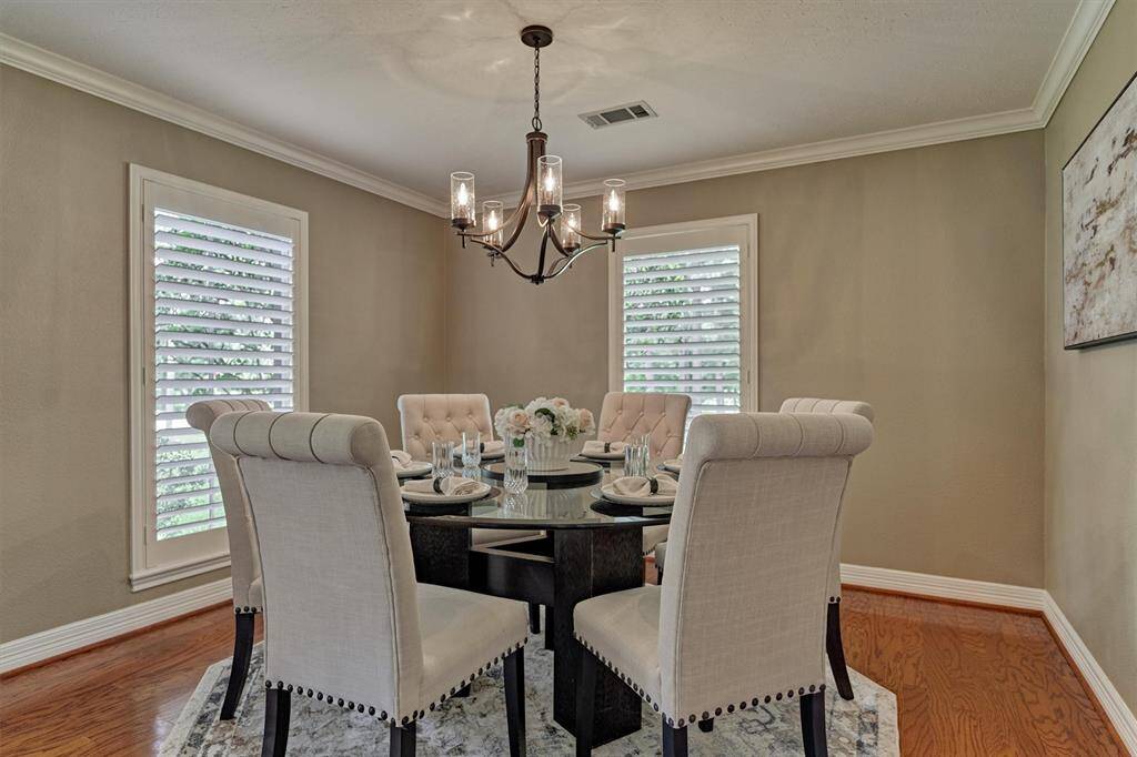 Corner windows with classic shutters craft a refined space for your furnishings.