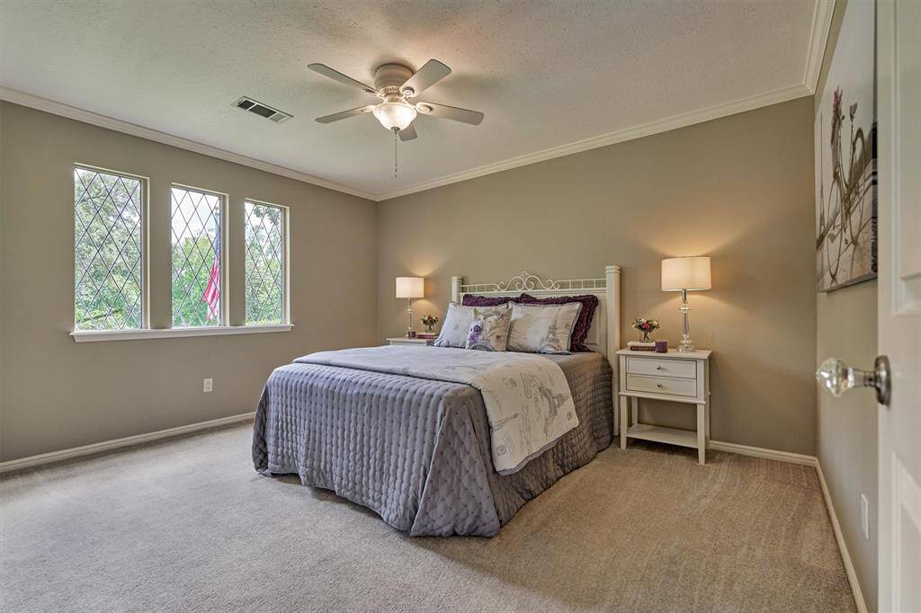 This spacious secondary bedroom features the Tudor-style diamond mullion windows. So much character.