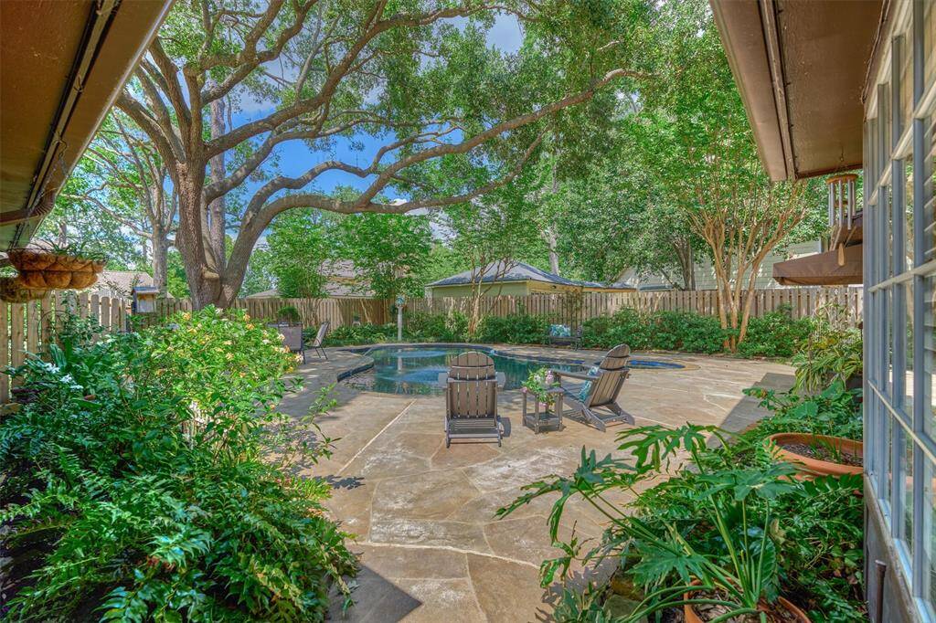 Discover a stunning backyard oasis as you cross the breezeway between the home and garage.