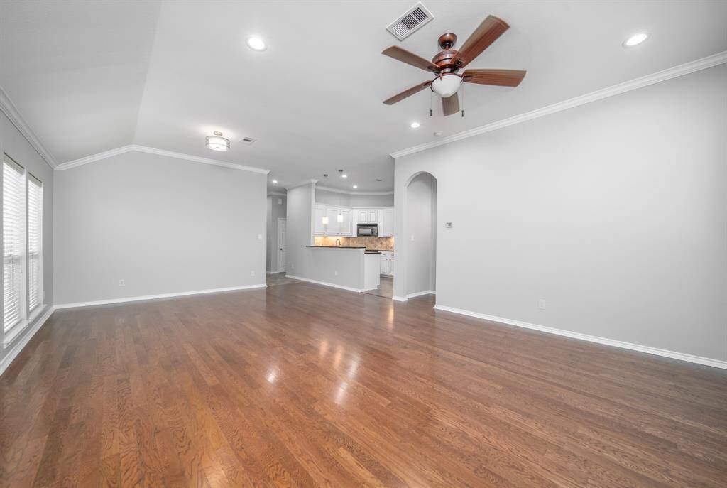 An abundance of light is reflected in the gorgeous continuous flooring in the living room and dining room!