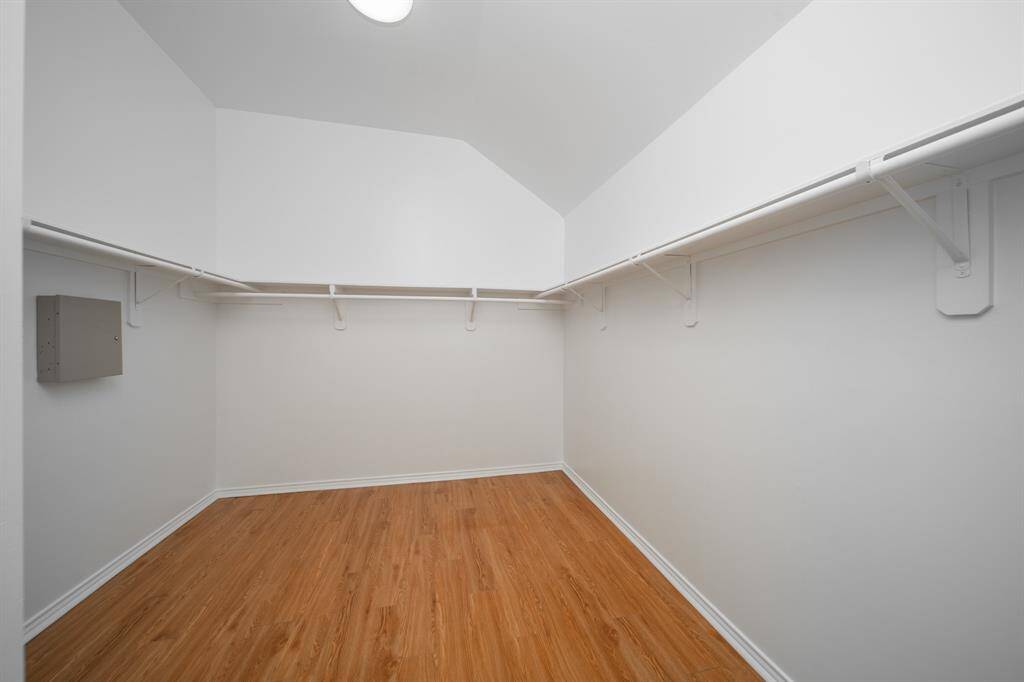 The primary walk-in closet almost looks like a room by itself! Add some shelving or dressers in order to free up space in the bedroom.