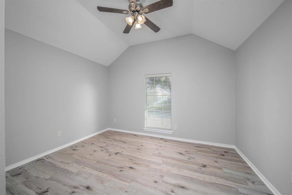 The 2nd bedroom rests under a vaulted ceiling with a window that faces the front yard. There is plenty of space here for a variety of bedroom designs.