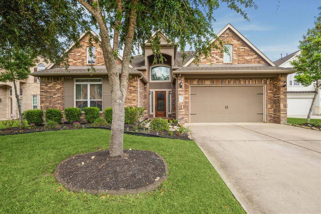 WELCOME HOME TO 614 YUAPON CREEK LANE! LAKE VIEW PROPERTY!This inviting home features a charming brick exterior, a spacious two-car garage, and well-maintained landscaping with lush greenery and mature trees, offering great curb appeal.