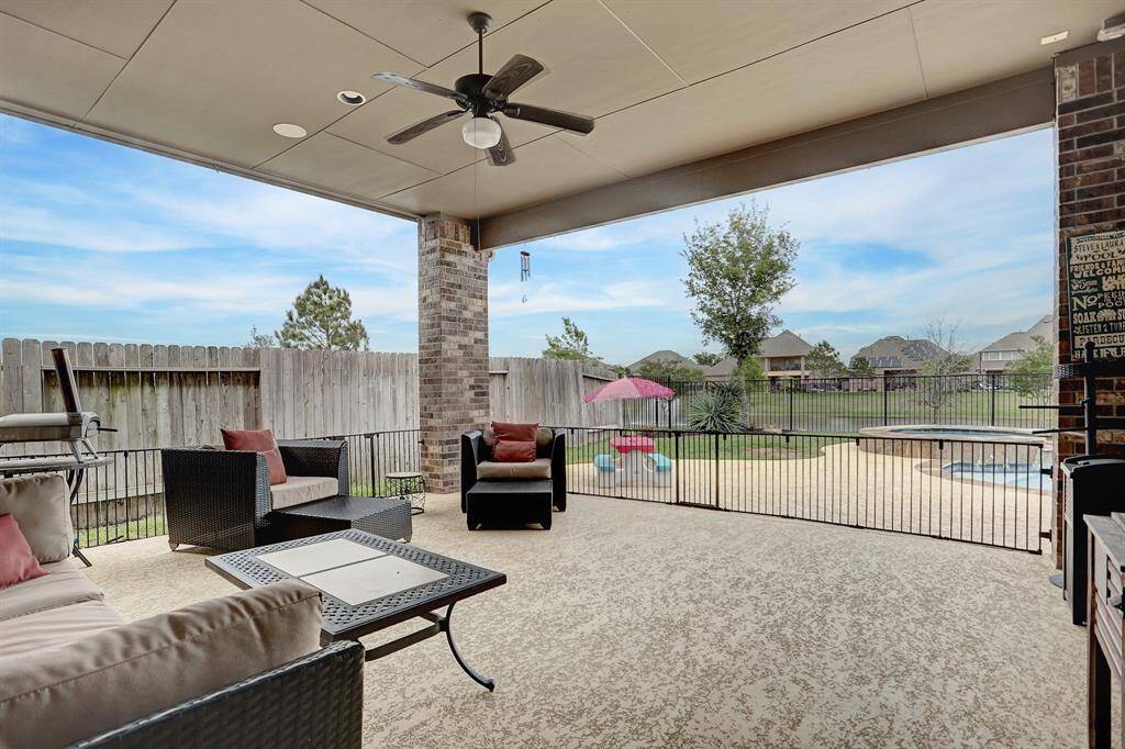 This covered patio is the perfect space for outdoor entertainment and relaxation. Its large pergola-style structure can shade the patio even during the hot summer. Beautiful view of the pool and water.