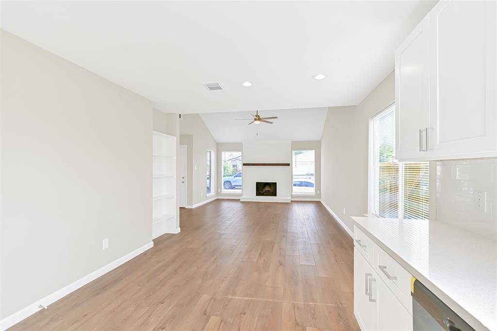 An alternate view showcases the open living spaces, offering the perfect backdrop for a flexible layout that seamlessly blends the living and dining areas.