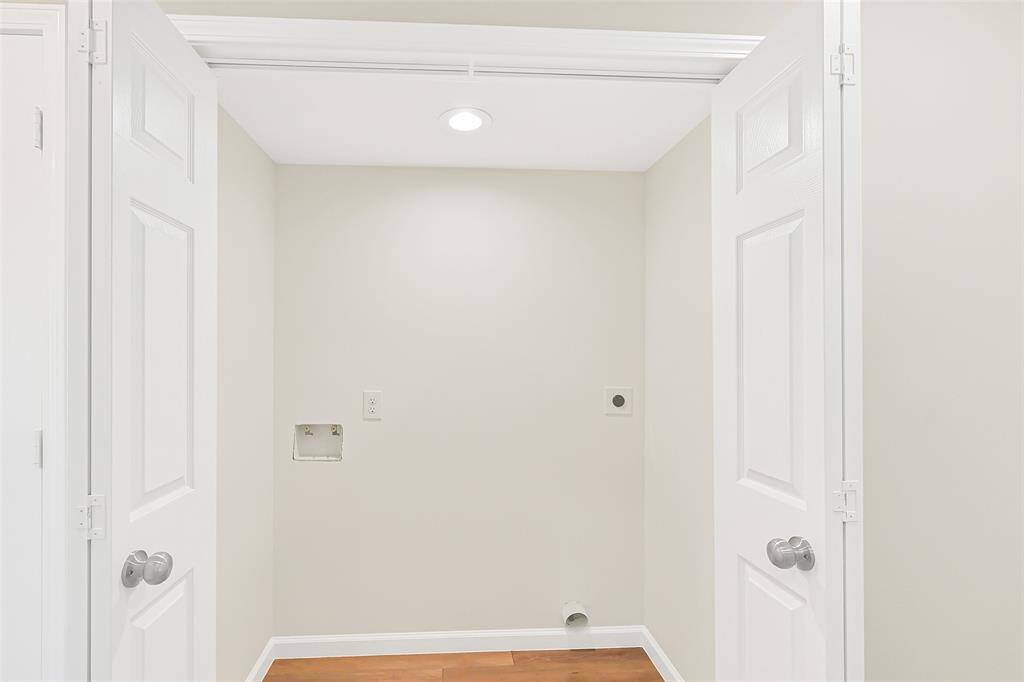 The utility room is conveniently located within the home, offering easy access for everyday tasks. Thoughtfully concealed behind stylish accordion doors, providing a neat and discreet space for laundry and additional storage needs.