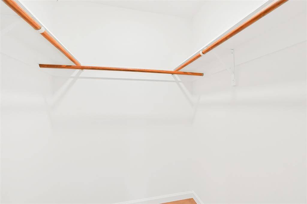A generously sized walk-in closet provides ample storage and organization options, making this primary bedroom as functional as it is stylish.