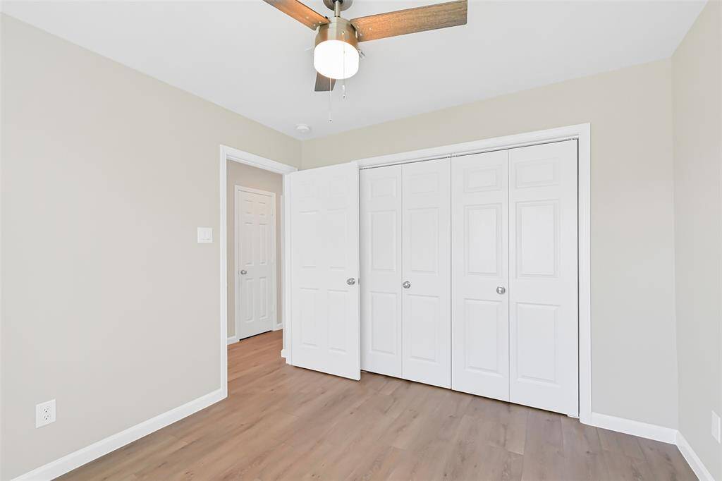 An alternate view of the secondary bedroom showcases a spacious closet and easy access to the full bathroom, offering privacy without needing to pass through the main living areas.
