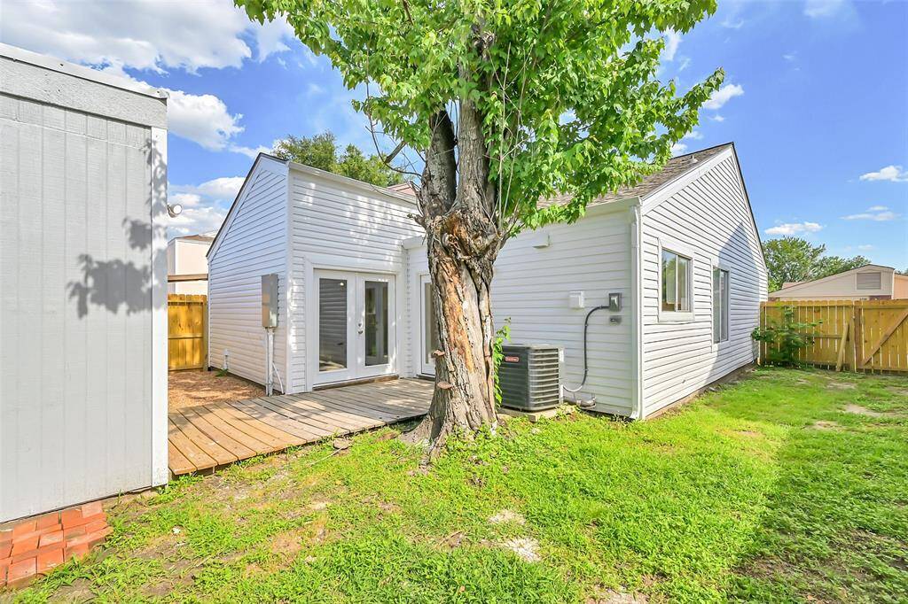 The backyard features easy access from the home’s main living area, leading to a spacious deck ideal for outdoor dining or lounging.
