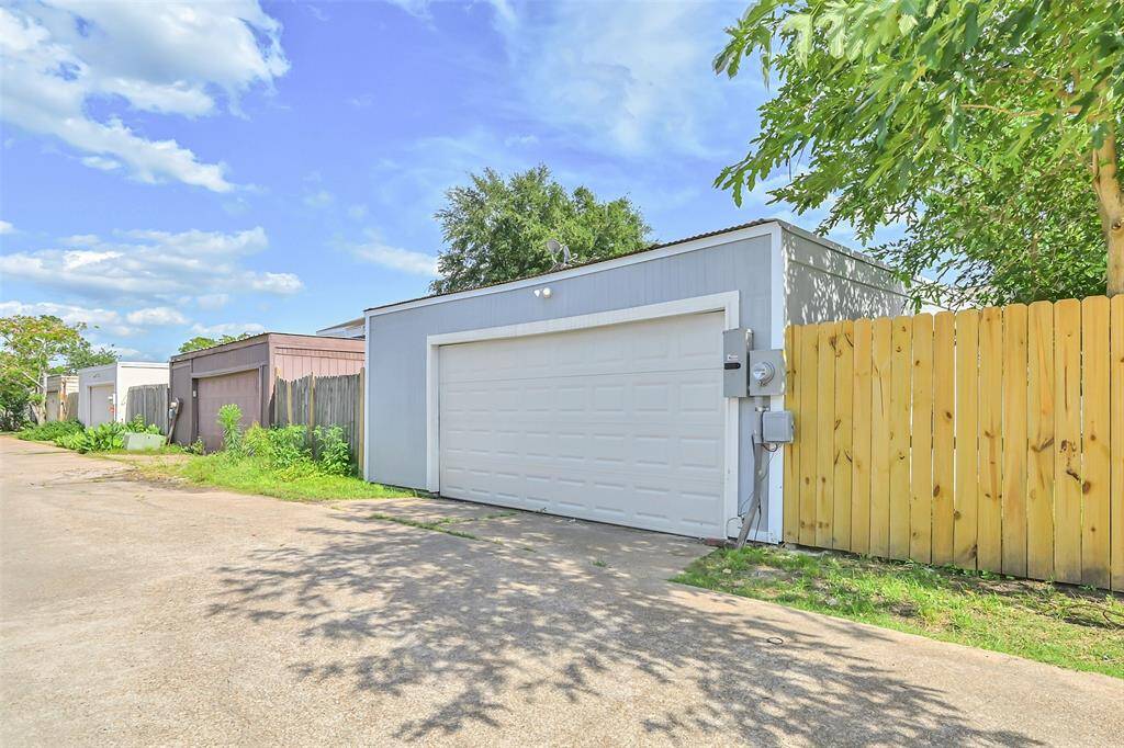 The detached garage located toward the back of the property offers convenience and privacy, providing ample space for storage or parking.