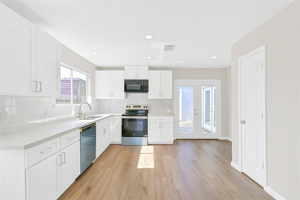 With ample storage, white cabinetry, and modern appliances, the kitchen is not only beautiful but practical, providing all the essentials for your cooking needs.