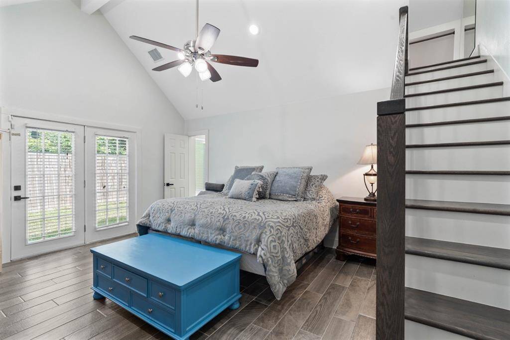 Primary bedroom also features high ceilings, an en-suite bathroom, his and hers closets and a view and door to  your backyard.