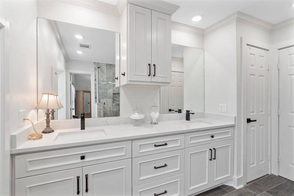 Dual sinks and custom cabinets also featured in the primary bathroom