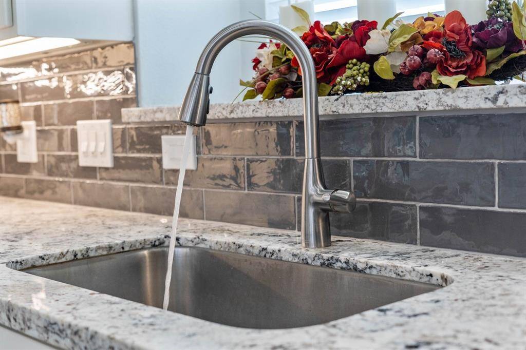 A close up of the undermount sink, check out the beautiful tiled backsplash.