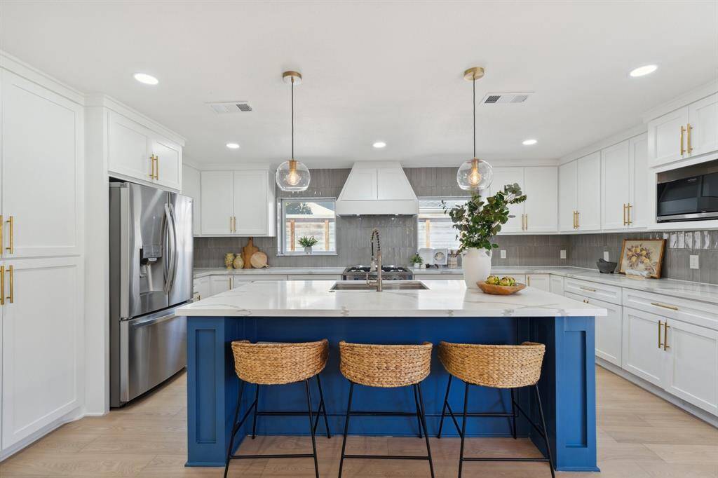 Designed to impress, the chef’s kitchen boasts a spacious accent island and an open layout perfect for cooking, gathering, and entertaining.