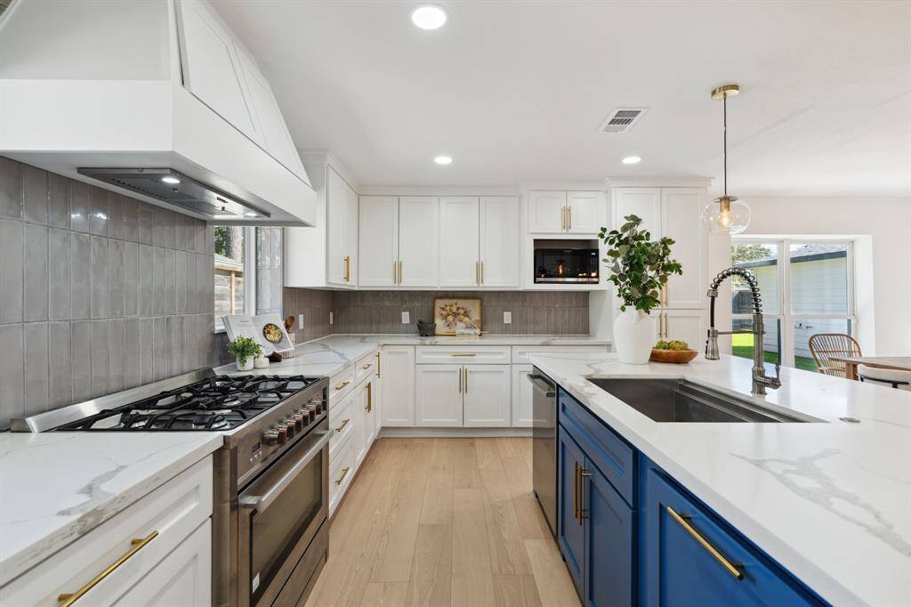 Featuring custom-built cabinetry, Zellige tile, stainless steel appliances, and quartz countertops.