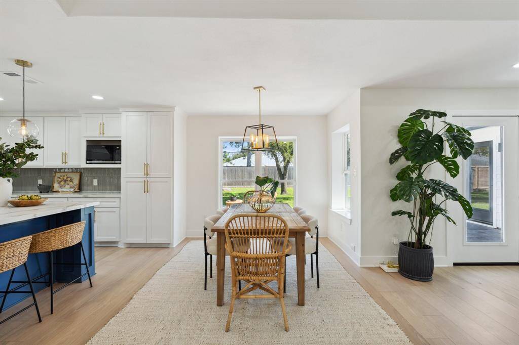 The dining area is perfectly positioned just off the kitchen, opening seamlessly into the living space. Large windows flood the area with natural light, creating an inviting setting for everyday meals or entertaining.