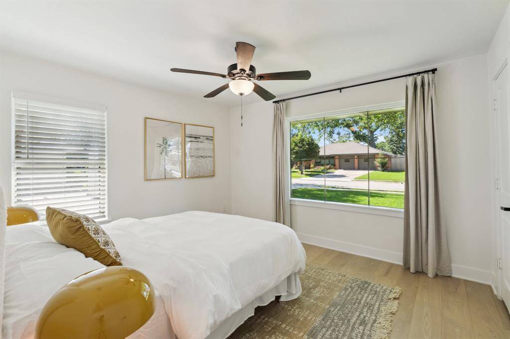 This airy secondary bedroom is flooded with bright natutal light coming through the window.