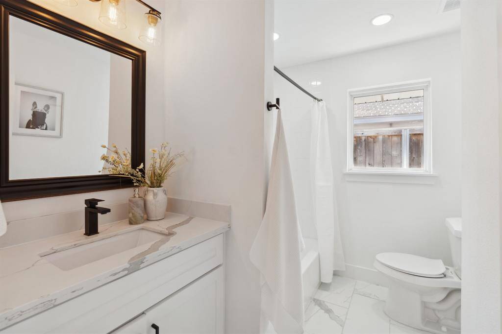 The two additional bedrooms share a beautifully updated hall bath.