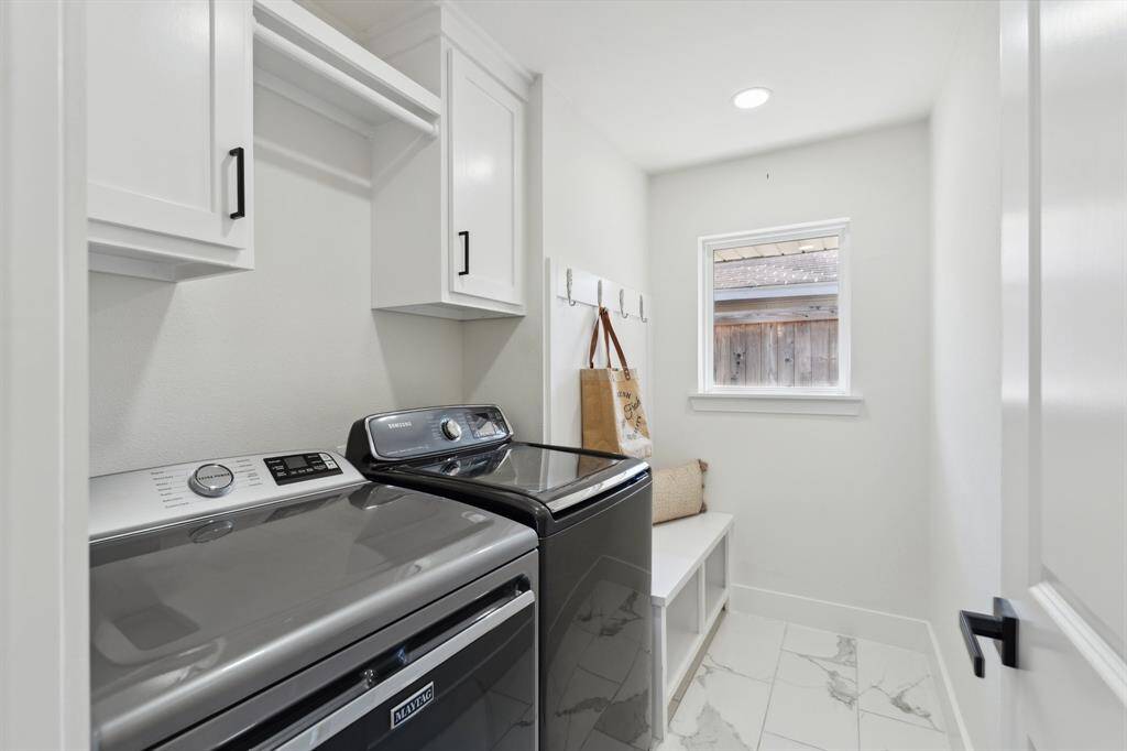 Designed for efficiency, the laundry room offers cabinet storage, a dedicated hanging area, and a mudroom zone to keep things organized.