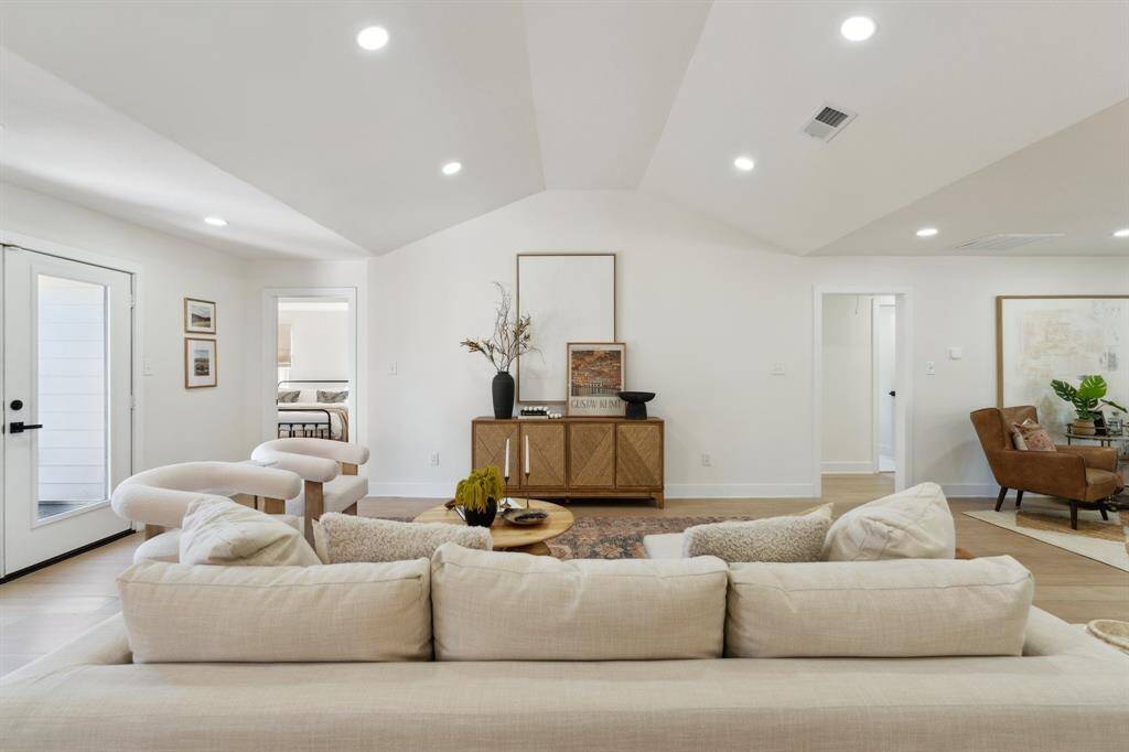 Elegant French doors anchors the far wall, offering picturesque views of the lush backyard and inviting in sunlight throughout the day.
