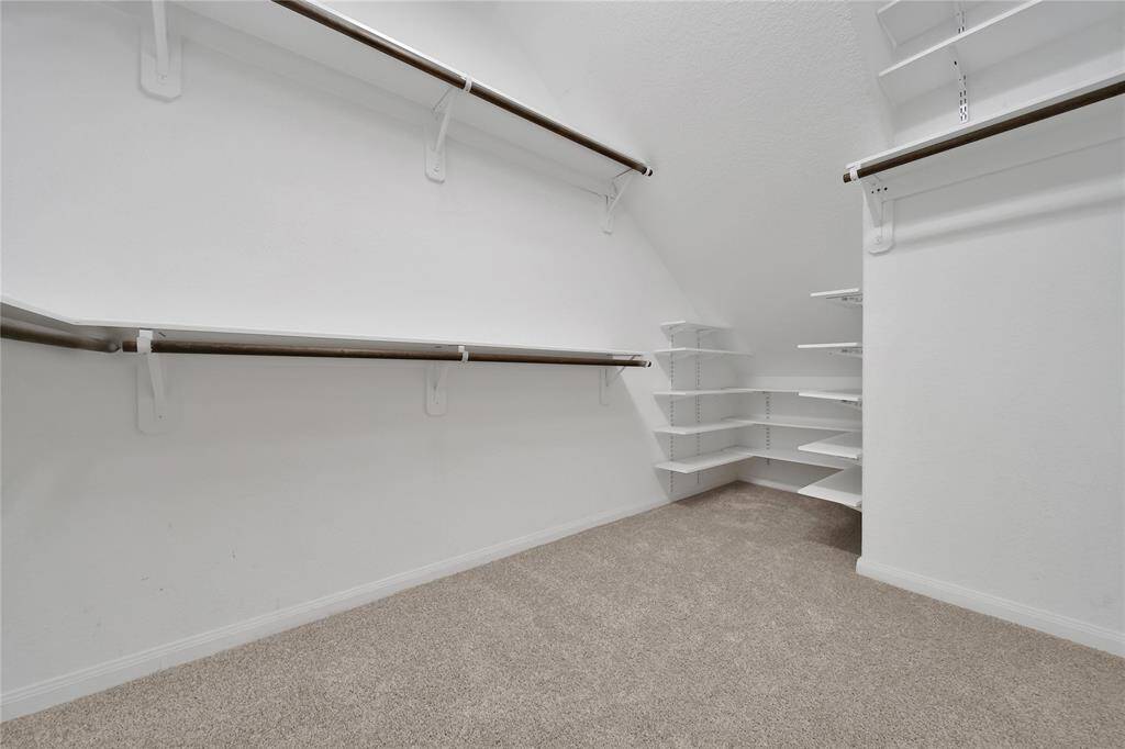 Spacious walk in closet in the primary room.