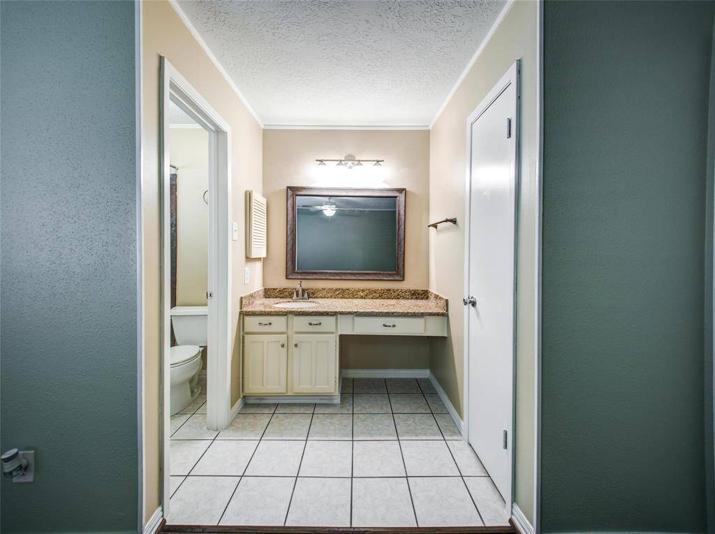 Master bathroom with granite countertop.