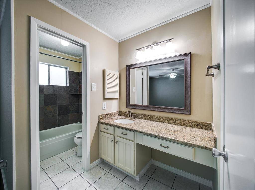 Master bath with separate bathtub and sink area for added convenience.
