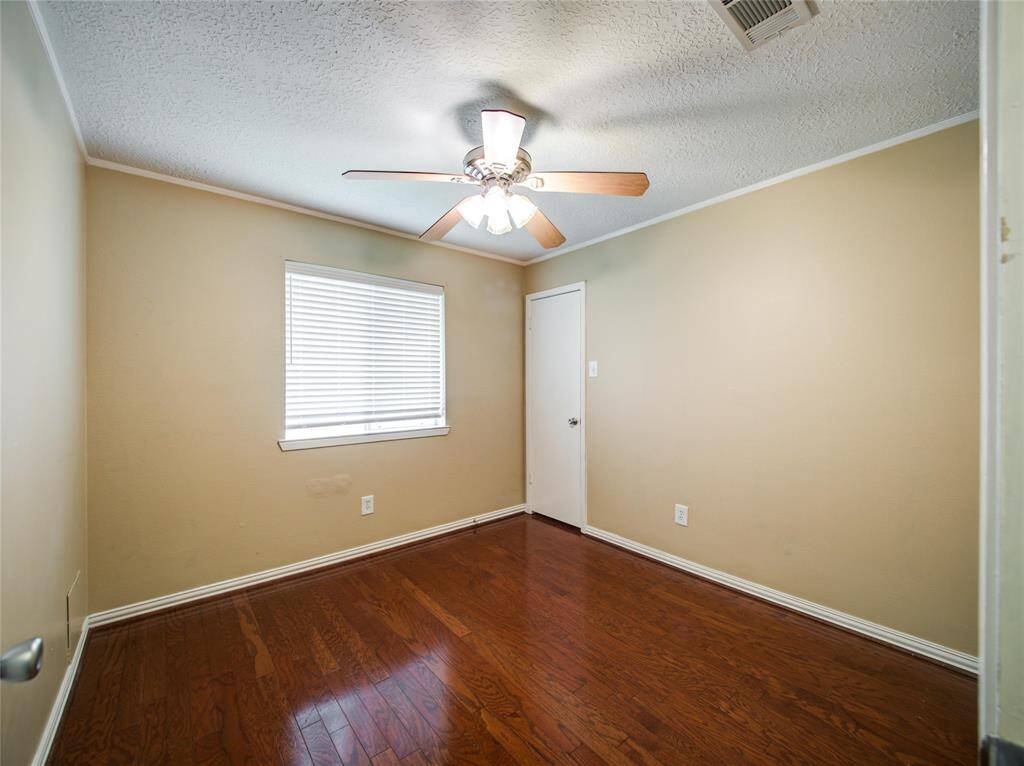 Bright guest Bedroom 1 with ceiling fan.