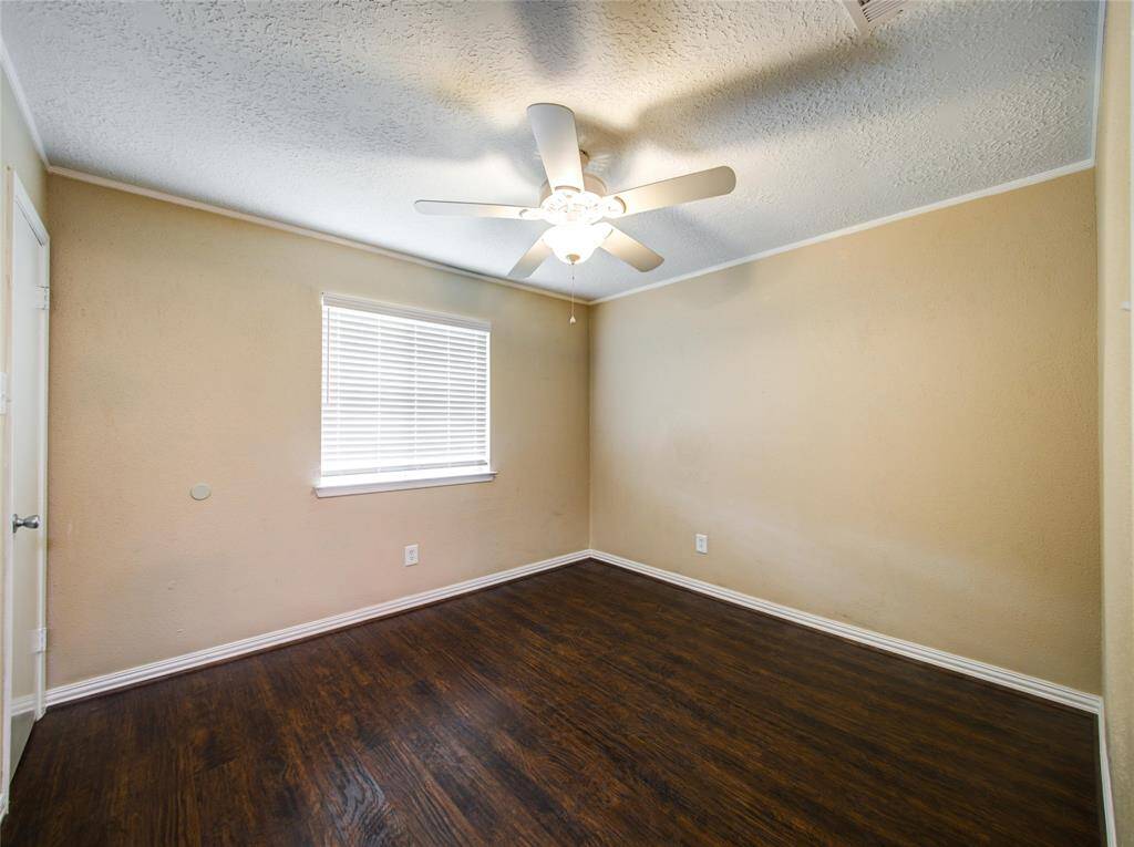 Guest Bedroom 2 with natural light and ceiling fan.