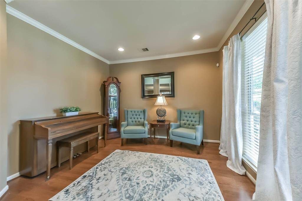This study features hardwood floors, and ample natural light from large windows.