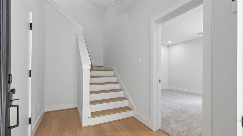 Upon entering is the staircase to the second floor and first floor bedroom.